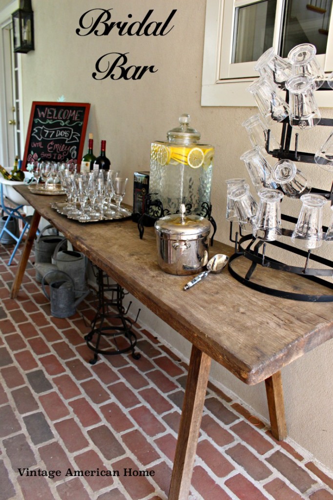 Bar set up and drink display for bridal shower, water with lemons, wine, chalkboard sign and mug holder.