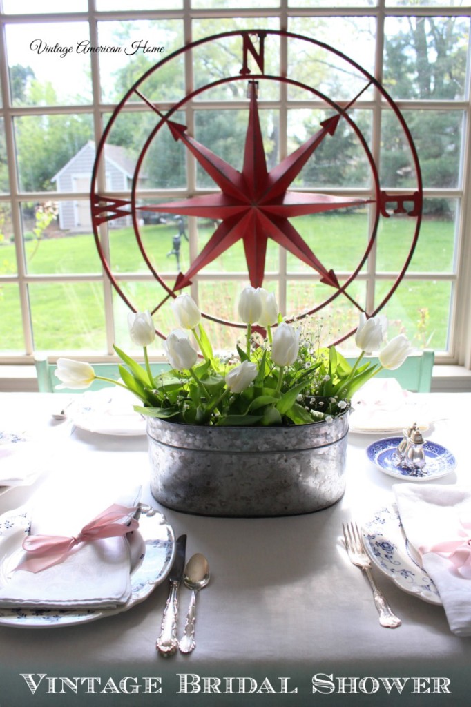 Vintage farm style rustic chic wedding bridal shower decorating with white tulips in glavanzied caddie and compass rose